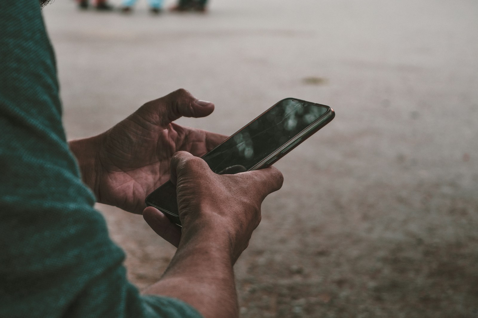 a person holding a cell phone in their hands