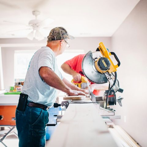 man standing infront of miter saw