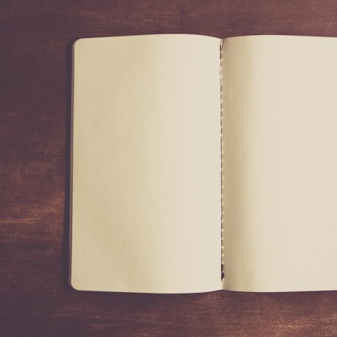Open notitieboekje met outfitschetsen en kleurstalen voor een persoonlijk lookbook