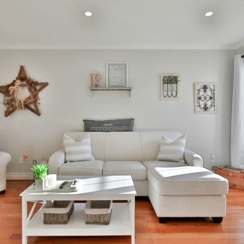 white leather sofa beside brown wooden table