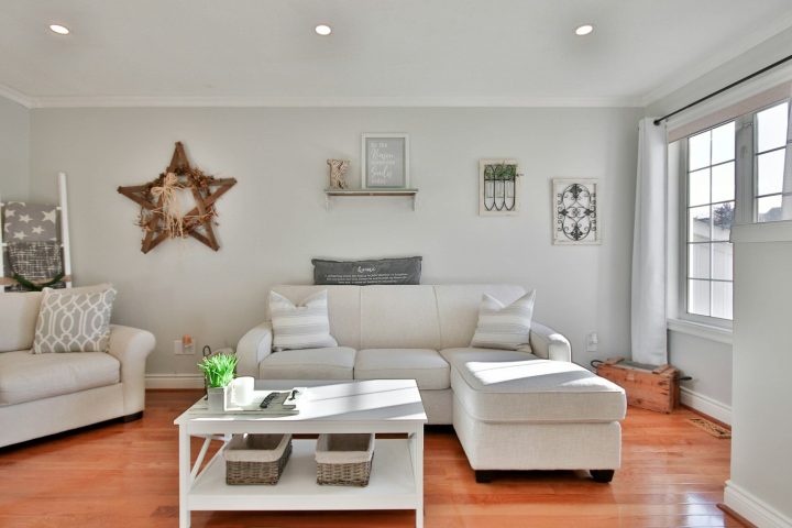 white leather sofa beside brown wooden table